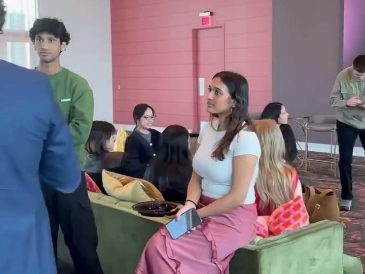 Students and guests talking after a panel
